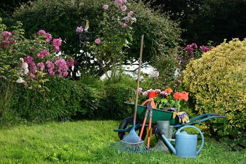 Operative using hedge trimmer with protective equipment